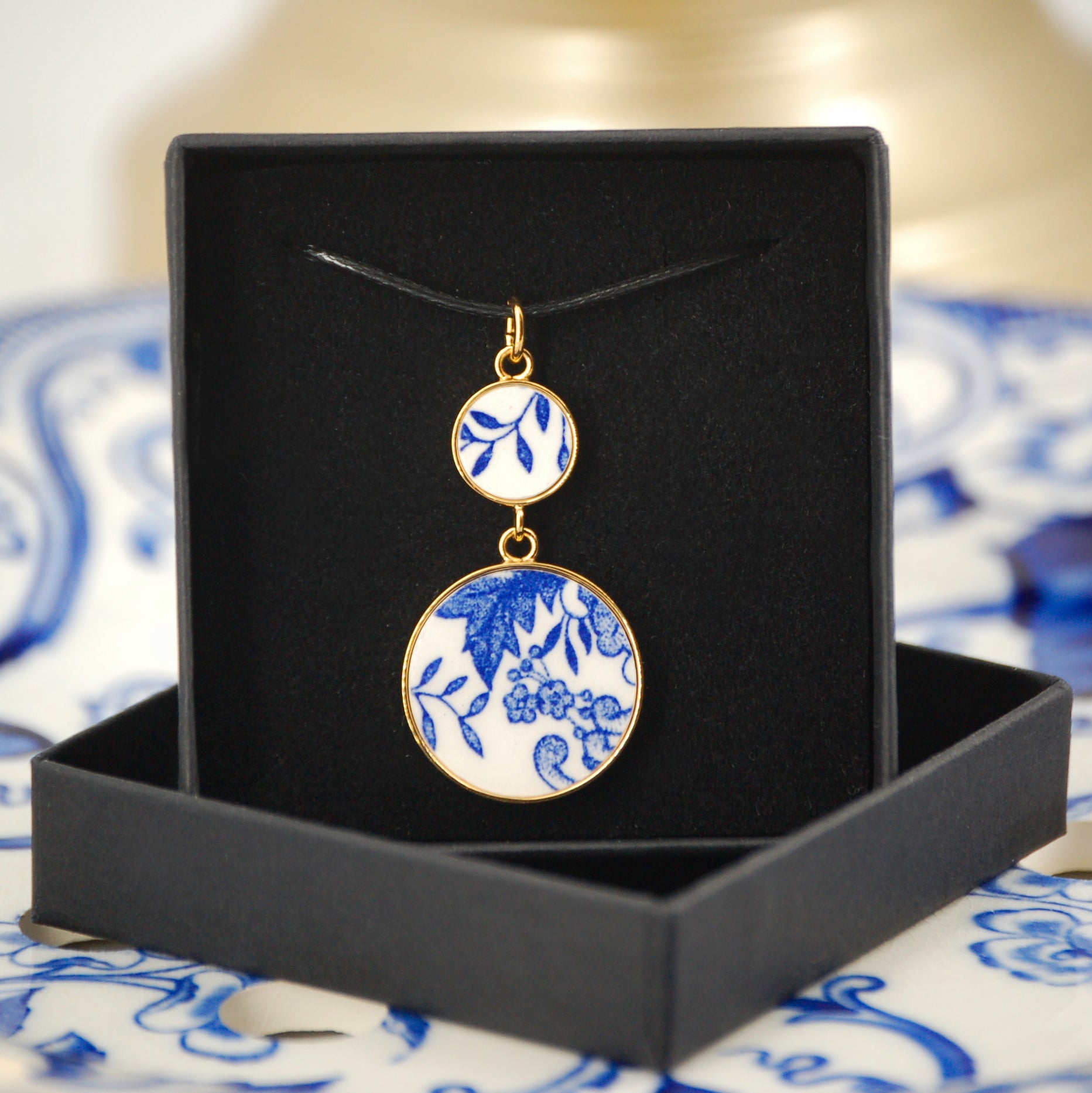 Pendant "Composition of flowers and blue leaves", gold finish
