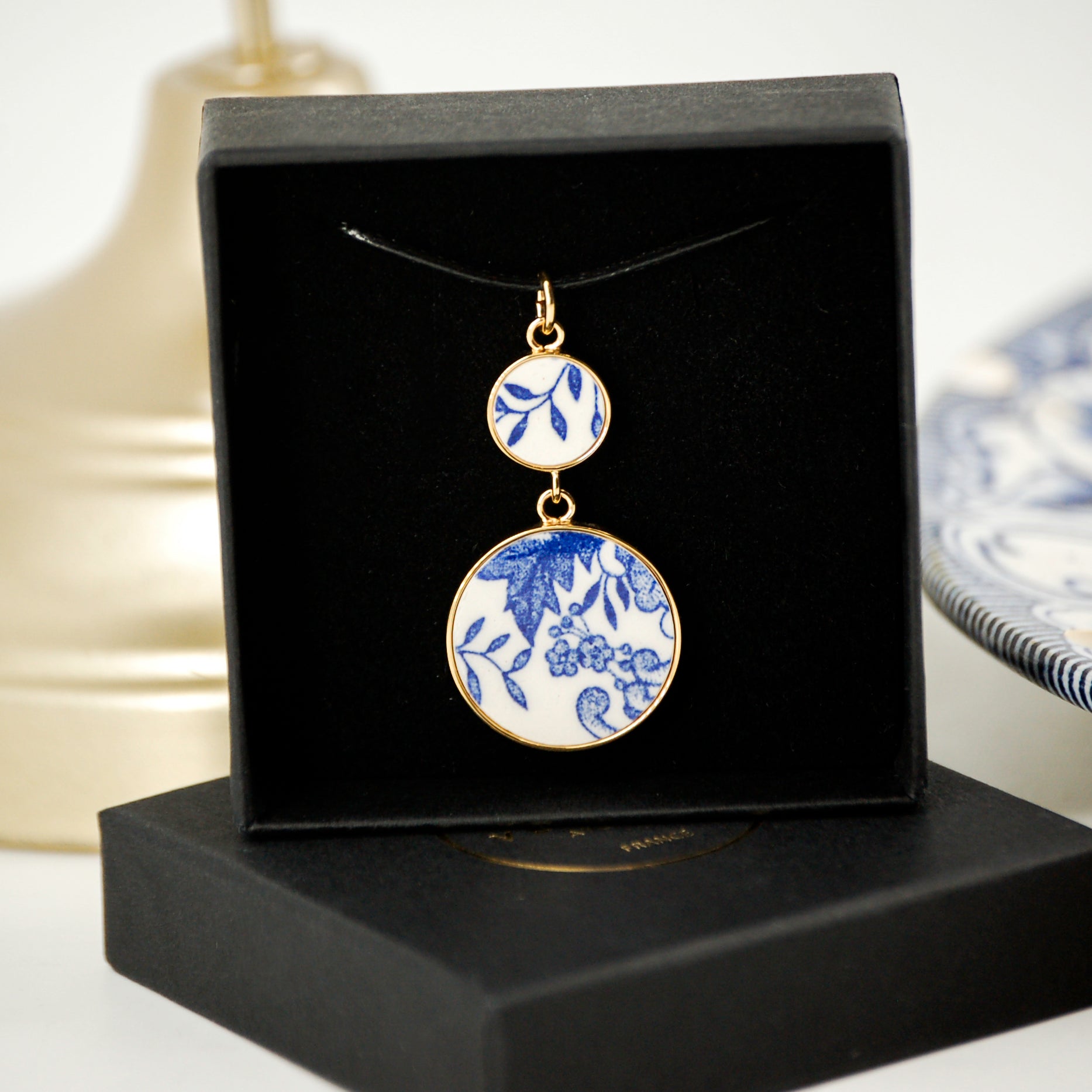 Pendant "Composition of flowers and blue leaves", gold finish