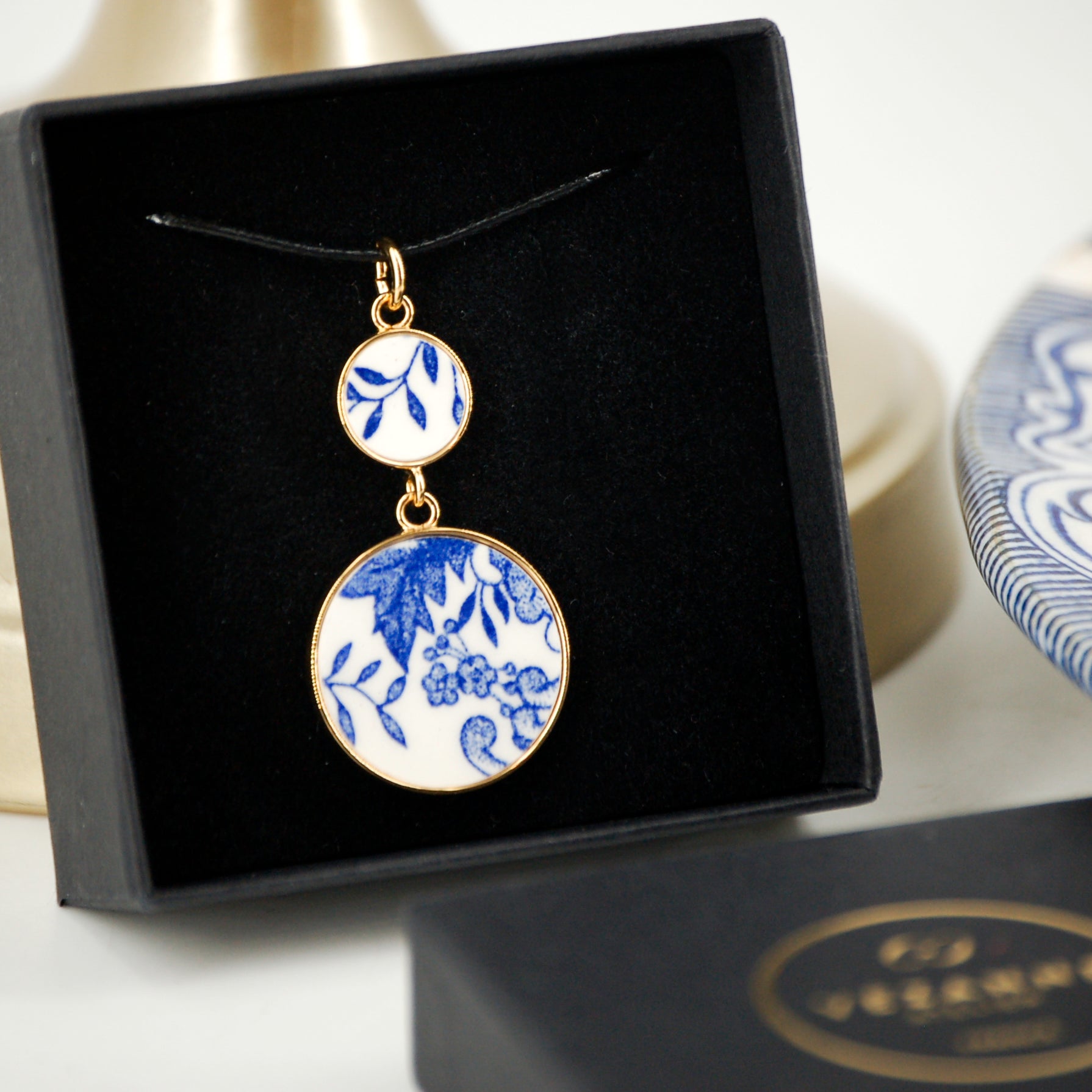 Pendant "Composition of flowers and blue leaves", gold finish