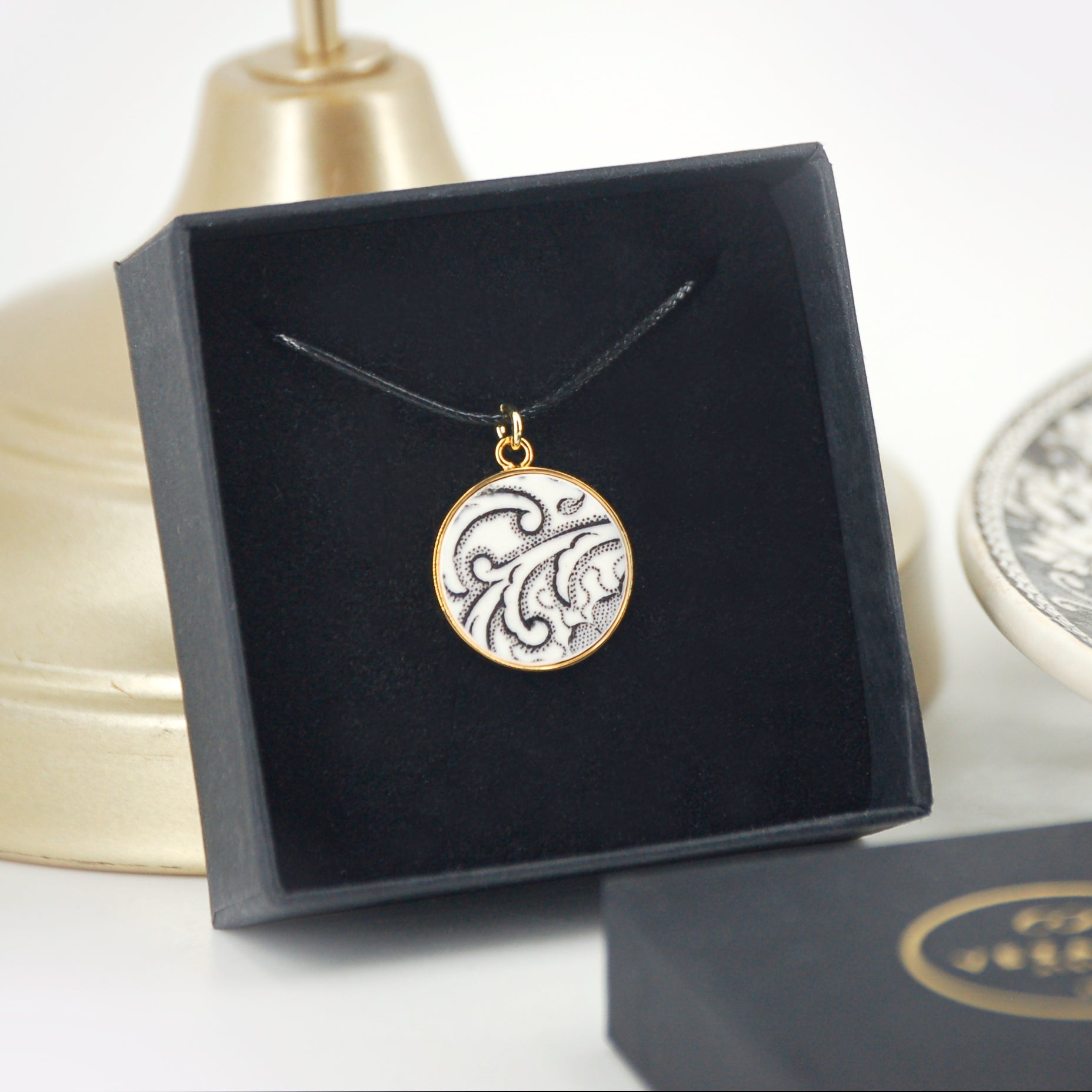Pendant "Flowers and scrolls in black and white", gold finish